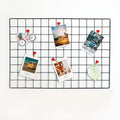 Pikify black steel grid photo frame, 45 by 65 cm, hung on a wall